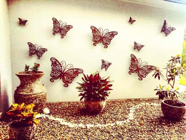 Garden art butterfly sculptures on exterior wall